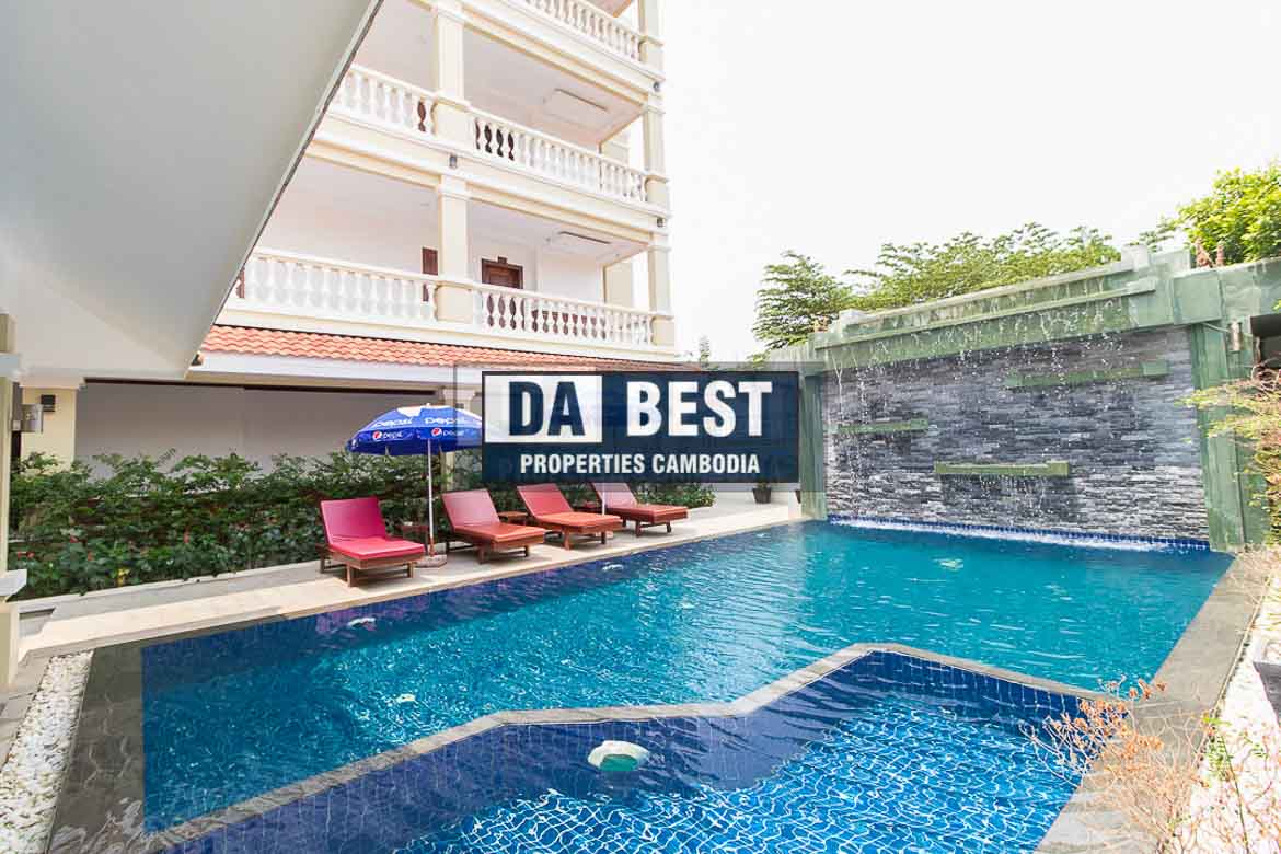 Generous 2 bedroom serviced apartment for rent in Siem Reap Angkor view of sunny poolside area with sunbeds and umbrellas