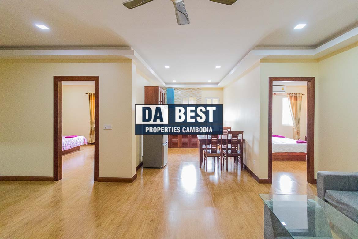 Generous 2 bedroom serviced apartment for rent in Siem Reap Angkor view of living area with ceiling fan and dining table and sofa 2